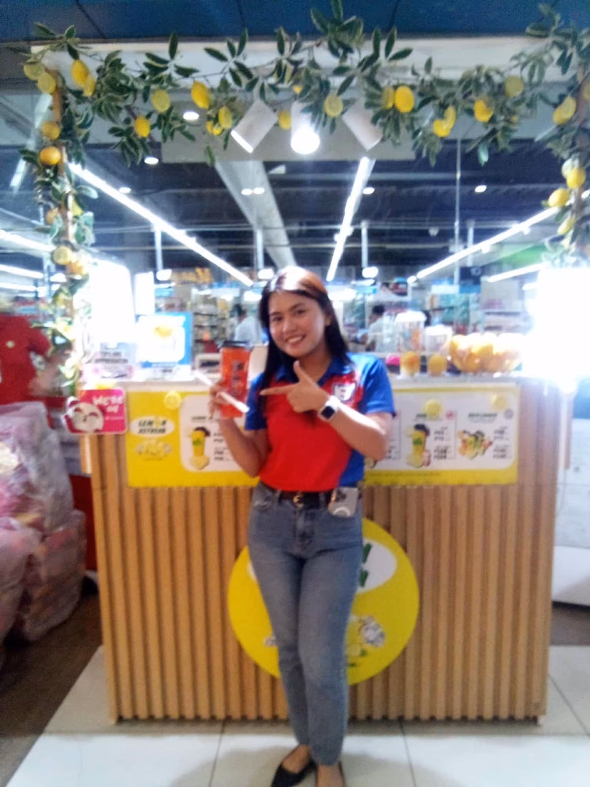 A customer standing beside the Lemon Refresh cart, which is decorated with lemons and foliage